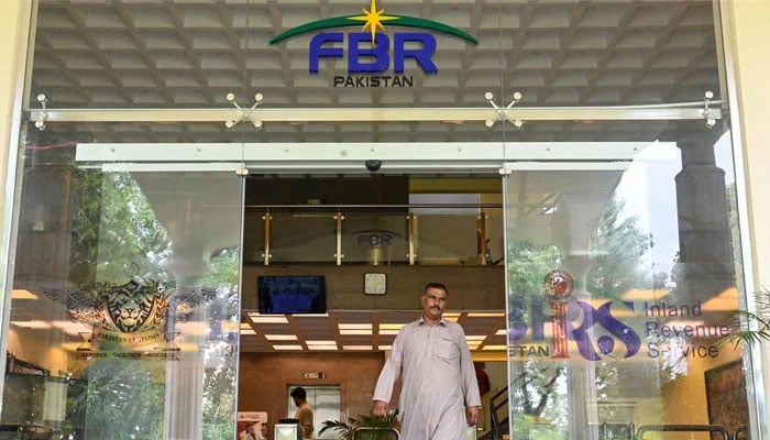 Representational image shows a man walking out of the Federal Board of Revenue (FBR) office in Islamabad on July 4, 2024. — AFP