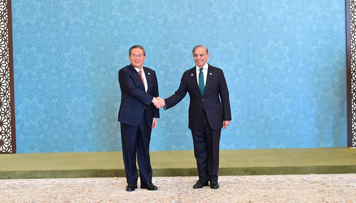 PM Shehbaz Sharif receives Chinese Premier Li Qiang upon his arrival at the venue of the 23rd SCO Council of Heads of Government meeting in Islamabad on Oct 16, 2024. — PID