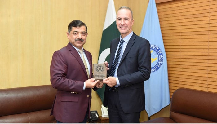 NUML Rector Major General (r) Shahid Mehmood Kayani (left) presents a shield to the Defence Attache` of the Embassy of France Colonel Jerome (right) at NUML on October 17, 2024. — Facebook/NUML