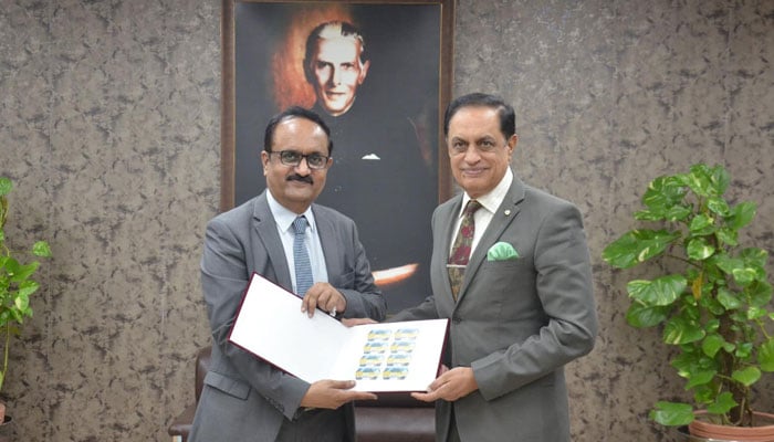 Additional Director General (Operation) Pakistan Post Rizwan Javed Hashmi (left) presents an album of the commemorative postage stamp to the Chairman WAPDA Engr Lt Gen Sajjad Ghani (retd) at WAPDA House on October 17, 2024. — Facebook/WAPDA