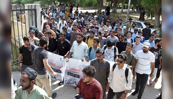 Students of the University of Karachi hold a banner and chant slogans during a protest in favour of their demands in front of the admin block at university premises, in Karachi on October 17, 2024. — Online