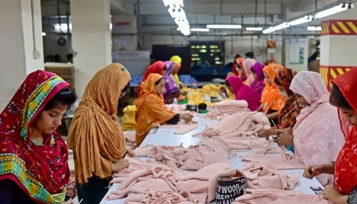 In this photograph taken on April 13, 2023, women work at a garment factory in Dhaka. — AFP