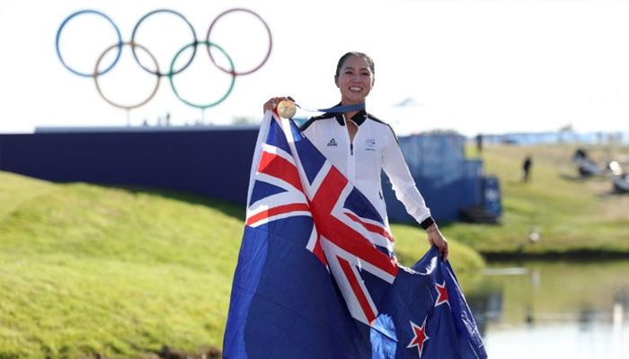 Gold medallist Lydia Ko of New Zealand poses with her medal and national flag as she celebrates after winning the event. — Reuters/file