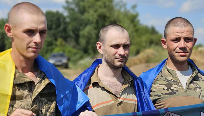 This handout photograph released by the Ukrainian presidential press service on July 17, 2024 shows Ukrainian prisoners of war posing for a photo following a swap at an undisclosed location in Ukraine. — AFP