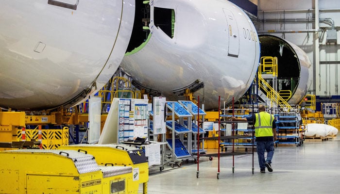 An employee walks past a fuselage section under construction at Boeings 787 Dreamliner campus in North Charleston, South Carolina, the United States, on May 30, 2023. — Reuters