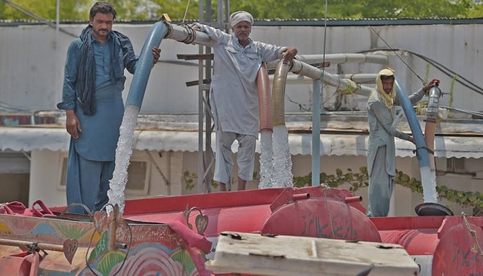 The representational image shows workers filling water tankers from a hydrant, to supply at residential areas for a charge on the outskirts of Islamabad. — AFP/File