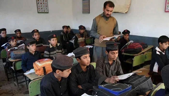 A teacher takes a class in a school in Peshawar, KP. — AFP/File