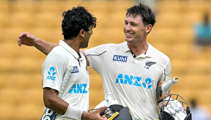 New Zealand´s Will Young (right) and Rachin Ravindra celebrate their team´s win against India at the end of their first Test cricket match in the M. Chinnaswamy Stadium of Bengaluru on October 20, 2024. — AFP