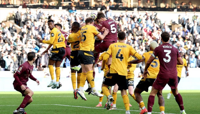 Manchester Citys John Stones rises to score the winner against Wolves. — AFP/file