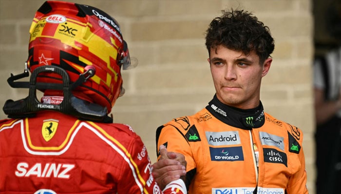 McLaren driver Lando Norris shakes hands with Ferraris Carlos Sainz after winning the pole position for the United States Grand Prix. — AFP/file