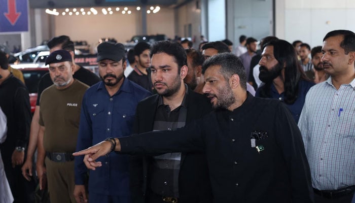 Punjab Minister for Sports, Labour and Human Resources Faisal Ayub Khokhar (centre) inspects the participating cars, motorcycles, and stalls during the auto show in Expo Centre Lahore on October 20, 2024. — Facebook@Faisal Ayub Khokhar