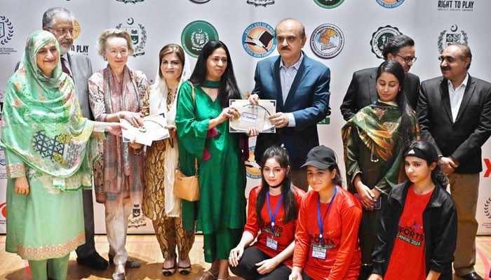 Federal Secretary, MoFE&PT, Mohyuddin Ahmad Wani gives certificates among winners during the closing ceremony of the 3-day Girls Sports Carnival 2024 organized by the  MoFE&PT at Pakistan Sports Board on October 20, 2024. — APP