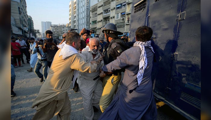 Police officials arrest protesters during the protest demonstration of the Baloch Yakjehti Committee at Karachi Press Club on October 20, 2024. — PPI