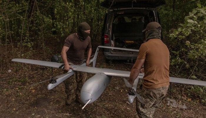 A file photo taken on August 11, 2024, shows Ukrainian military drone operators preparing a Poseidon reconnaissance unmanned aerial vehicle on their position, in the Sumy region, near the border with Russia, amid the Russian invasion of Ukraine. — AFP