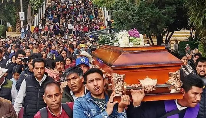 People carry the coffin of Catholic priest Marcelo Perez. — AFP