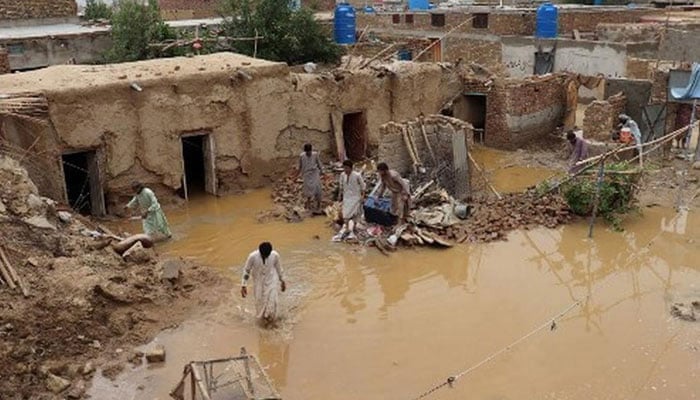 Residents clear debris of a damaged house due to a heavy monsoon rainfall on the outskirts of Quetta, Balochistan on July 5, 2022.— AFP