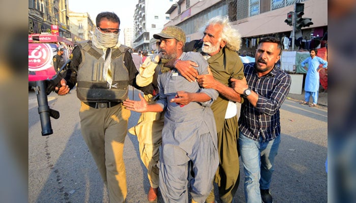 Police officials arrest protesters during the protest demonstration of the Baloch Yakjehti Committee for recovery of their missing loved one, at Karachi Press Club on October 20, 2024. — PPI