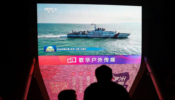 A giant screen shows news footage of military drills conducted in the Taiwan Strait and areas to the north, south and east of Taiwan, by the Eastern Theater Command of the Chinese Peoples Liberation Army (PLA), in Beijing, China October 14, 2024. — Reuters