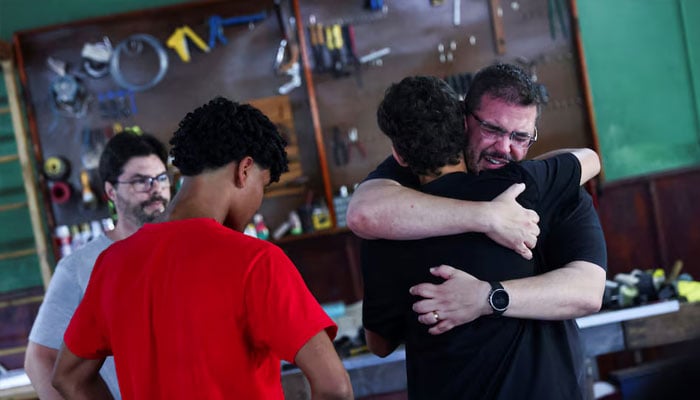 Relatives of victims of the accident that killed nine members of the rowing team of the social project Remar Para o Futuro hug each other at the clubs headquarters, in the city of Pelotas, in the state of Rio Grande do Sul, Brazil, October 21, 2024. — Reuters