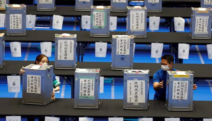 Election officials transport ballot boxes during Japans upper house election at a counting centre in Tokyo, Japan, July 10, 2022.—Reuters