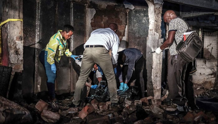 Forensic specialists and emergency responders seal a body bag containing a deceased person after a fuel truck explosion in Kigogwa, on October 22, 2024. — AFP