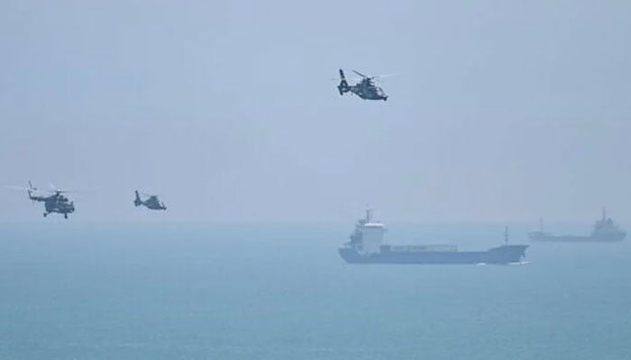 Chinese military helicopters fly past Pingtan island, one of mainland Chinas closest point from Taiwan, in Fujian province on August 4, 2022. — AFP