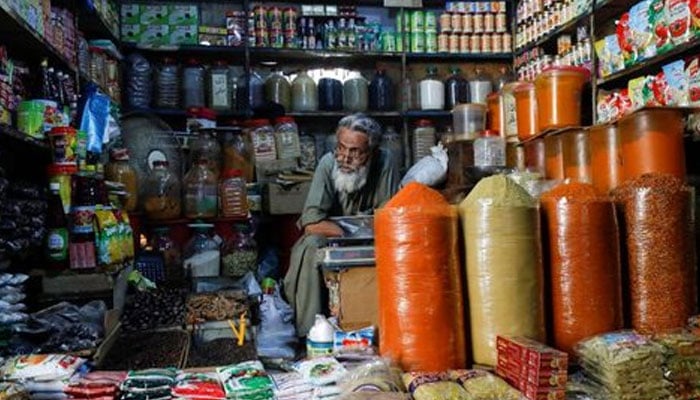 A shopkeeper waits for customers while selling spices and groceries items at the retail market in Karachi, — Reuters/File