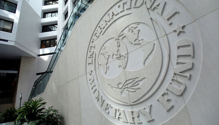 The International Monetary Fund (IMF) logo is displayed outside its headquarters in Washington, DC, on October 8, 2022. — AFP