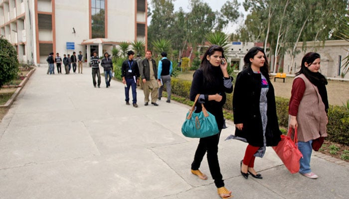 In this picture taken on January 13, 2022, students gather at a yard of a university. — AFP/file