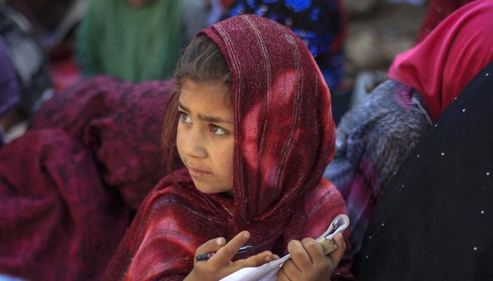 A girl attends a class at a makeshift school on the outskirts of Islamabad. — Reuters/File