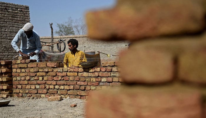 Flood-affected victims rebuild their house in Dadu district in Sindh. — AFP/File