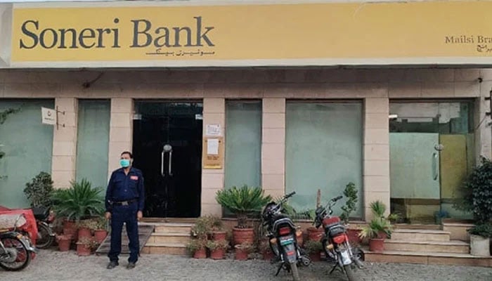 A security personnel standing outside a Soneri Bank branch in this image released on July 13, 2022. — Facebook@Soneri Bank Mailsi branch