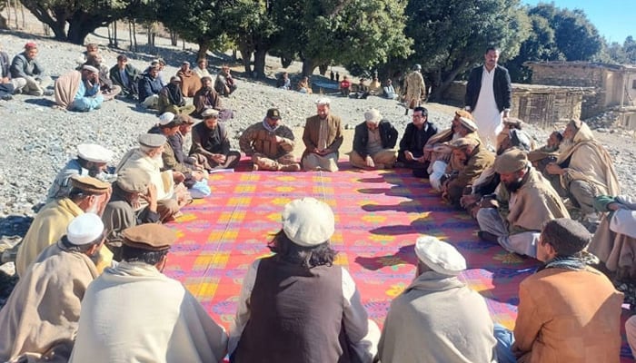 This image shows local officials and elders during a jirga in KP on January 10, 2024. — Facebook@AssistantCommissionerUpperKurram