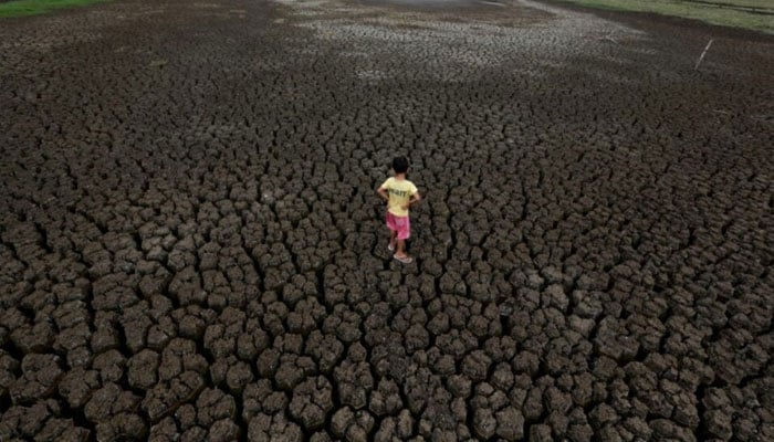 A boy, 5, stands on the cracked ground of the Boqueirao reservoir in the Metropolitan Region of Campina Grande, Paraiba state, Brazil, February 13, 2017. — Reuters