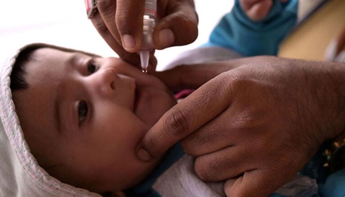 A health worker administering polio drops to an infant at a railway station during the start of polio campaign in Hyderabad on Feb 26, 2024. APP