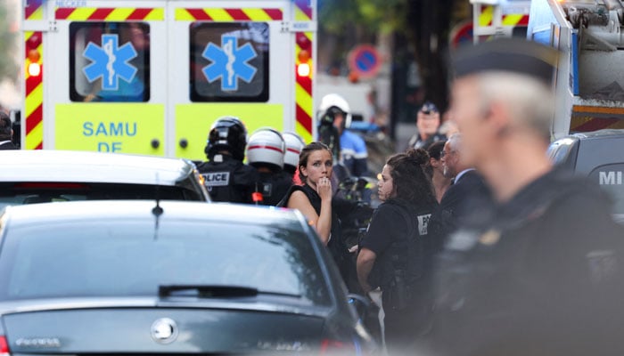 Members of police stand next to an ambulance after a police officer was injured in an attack.—Reuters/File