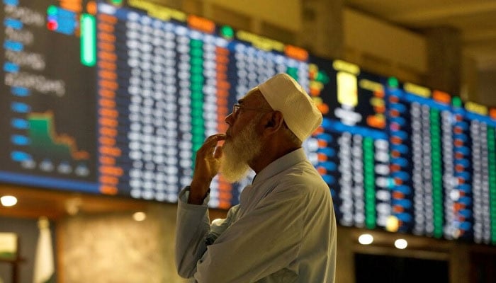 A stock broker reacts while monitoring the market on the electronic board displaying share prices during trading session at the Pakistan Stock Exchange, in Karachi, Pakistan July 3, 2023.— Reuters