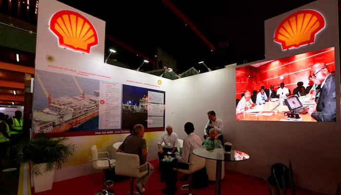 People sit at the Shell booth on the day of the opening of the Nigeria Oil and Gas 2022 meeting in Abuja, Nigeria on July 4, 2022. — Reuters