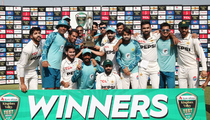 Pakistan players pose for a group photo with the trophy after winning the Test series against England in Rawalpindi on October 26, 2024. — PCB