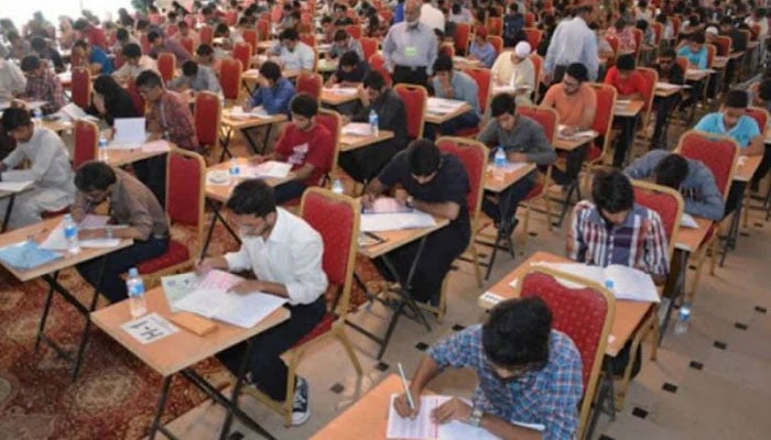 Students give an entry test in the Examination hall for admission in University Education. — APP/File