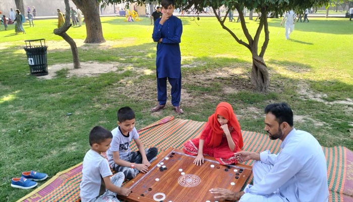 Children playing Carrom Board  Khedan Lahore Dian’ event organized by WCLA. —Facebook@WCLAuthority