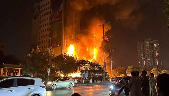 Fire can be seen engulfing the high-rise building in Karachi on March 12, 2023. — Geo News/Qamar Ali