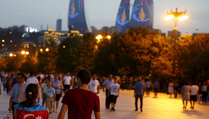 A girl, draped in Azerbaijans national flag, walks with a boy on a street in downtown Baku, Azerbaijan —Reuters/File