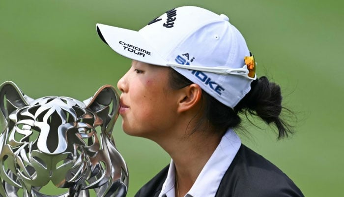 Chinas Yin Ruoning kisses the trophy after winning the LPGA Maybank Championship golf tournament at the Kuala Lumpur Golf and Country Club on October 27, 2024. —AFP