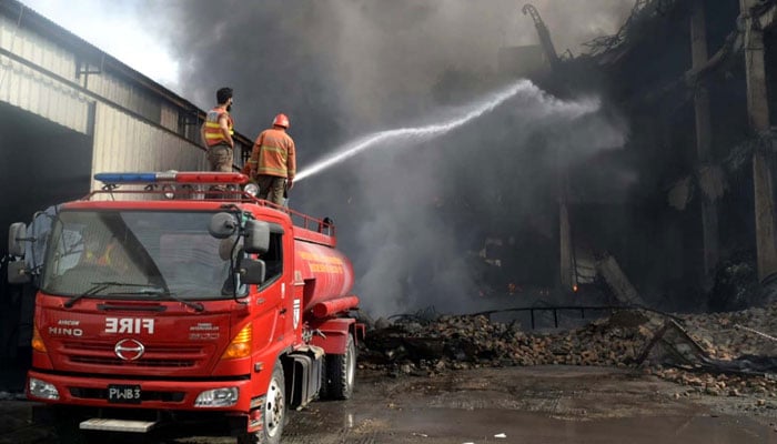 Fire brigade officials extinguish fire in Industrial Estate Hayatabad, Peshawar on October 27, 2024. — PPI