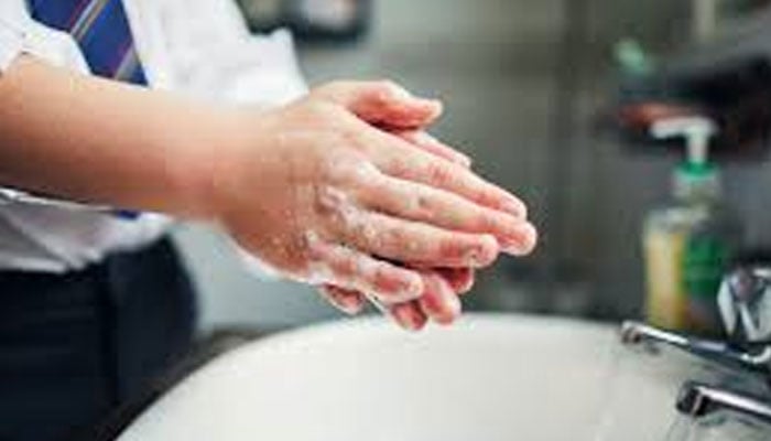 A representational picture of student washing hands. — App/File