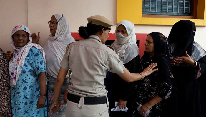 Women in New Dehli India waiting for their turn to vote. —Reuters/File