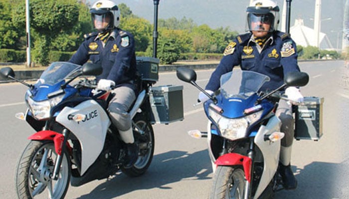 Two traffic police men on bikes in action.—islamabadpolice.gov.pk/file