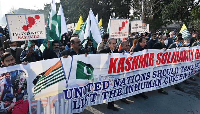 People carry a banner during a rally to mark Kashmir Solidarity Day in Islamabad, Pakistan. — AFP/File