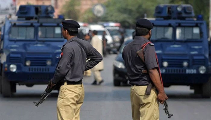 Two police personnel stand guard. — AFP/File